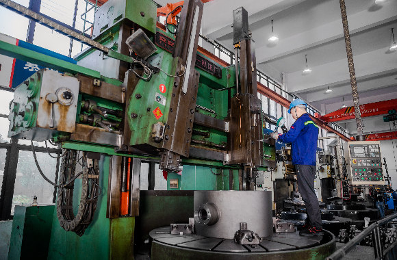 a male worker working in front of dombor's equipment
